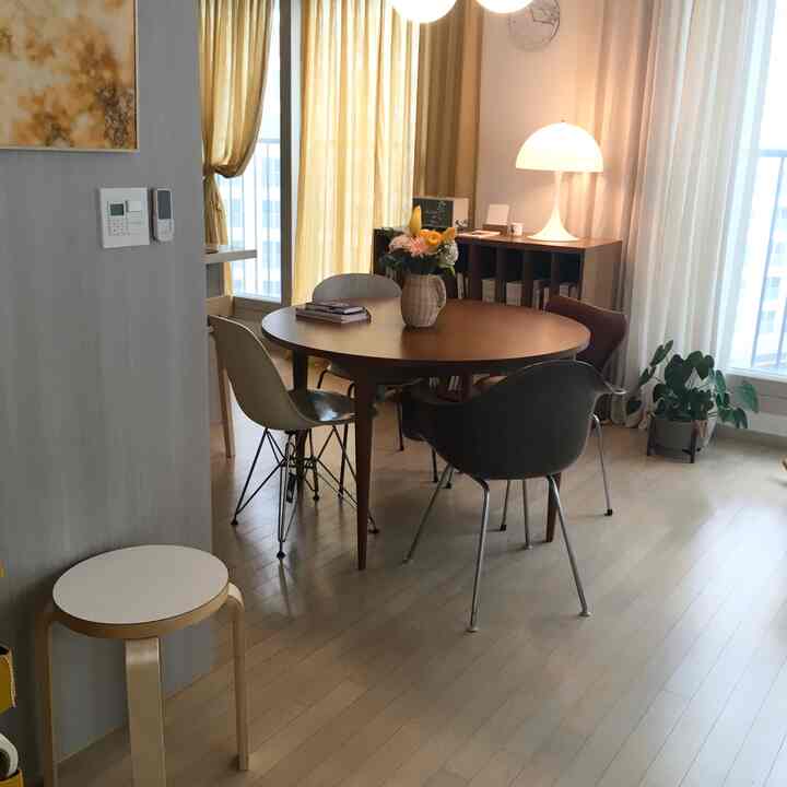 Beige and natural toned dining room featuring a round table and four chairs in a cozy setting