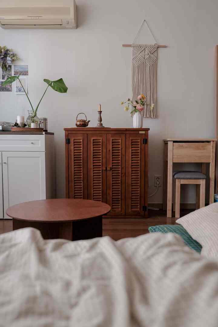 Cozy bedroom-living space with natural tones and wood furniture blending harmoniously