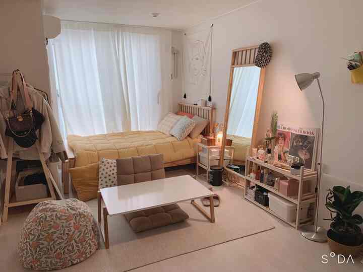 Cozy single household bedroom with yellow bedding and natural wood furniture