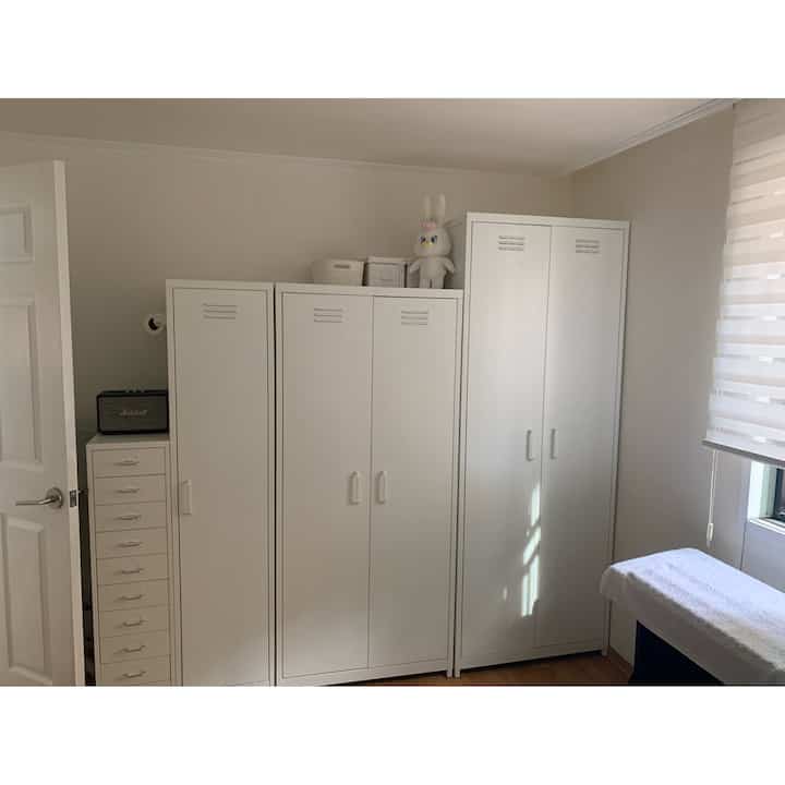 White-toned small room featuring Market B metal wardrobes and storage cabinets with a simple and modern atmosphere