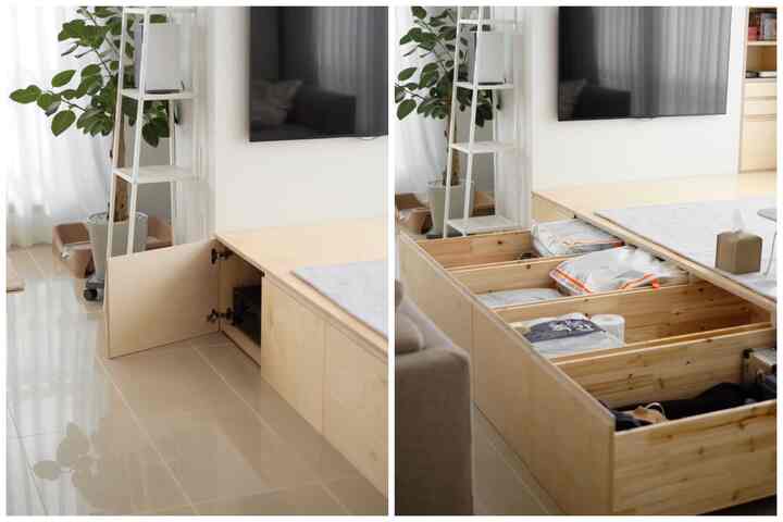 White and wood tone living room featuring built-in deep drawers under a raised platform, creating a clean and modern space