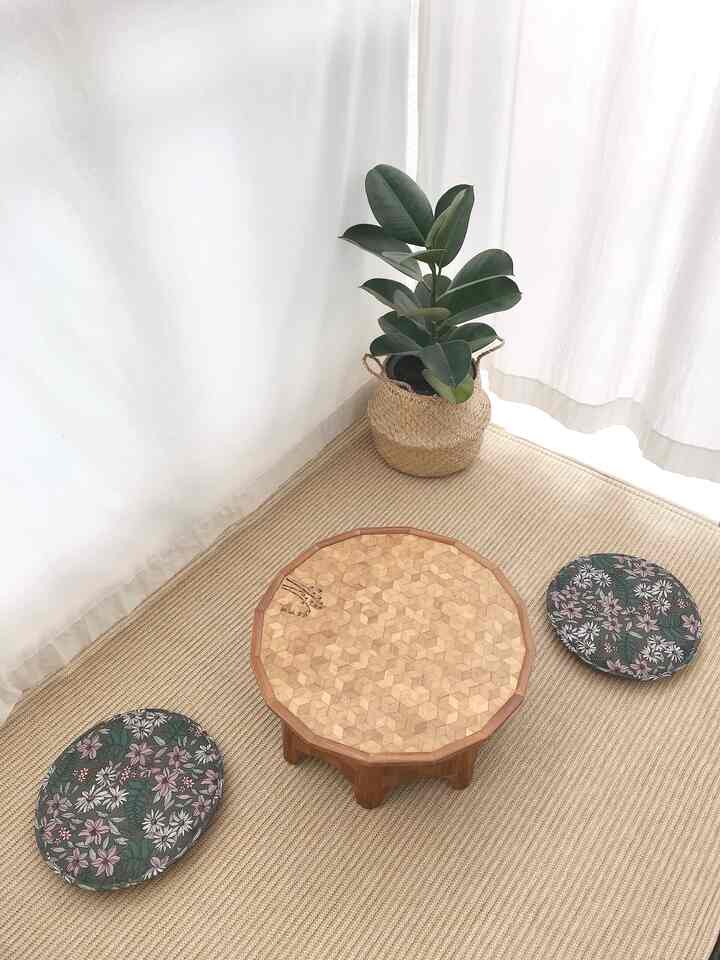Natural color veranda space with wooden patterned table and plant arranged in a cozy home cafe setting