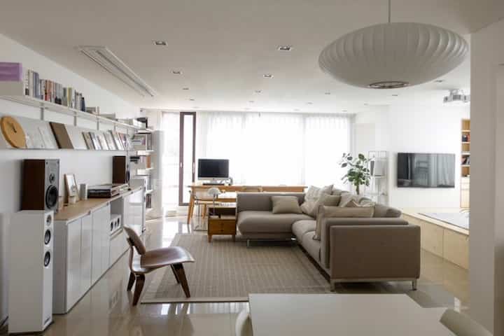 White and beige tone living room featuring sofa and lounge chair with a simple and natural atmosphere