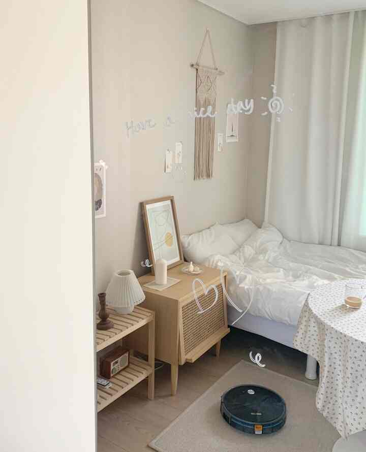 Beige-toned bedroom featuring natural wood furniture and white bedding, creating a calm and cozy single household space