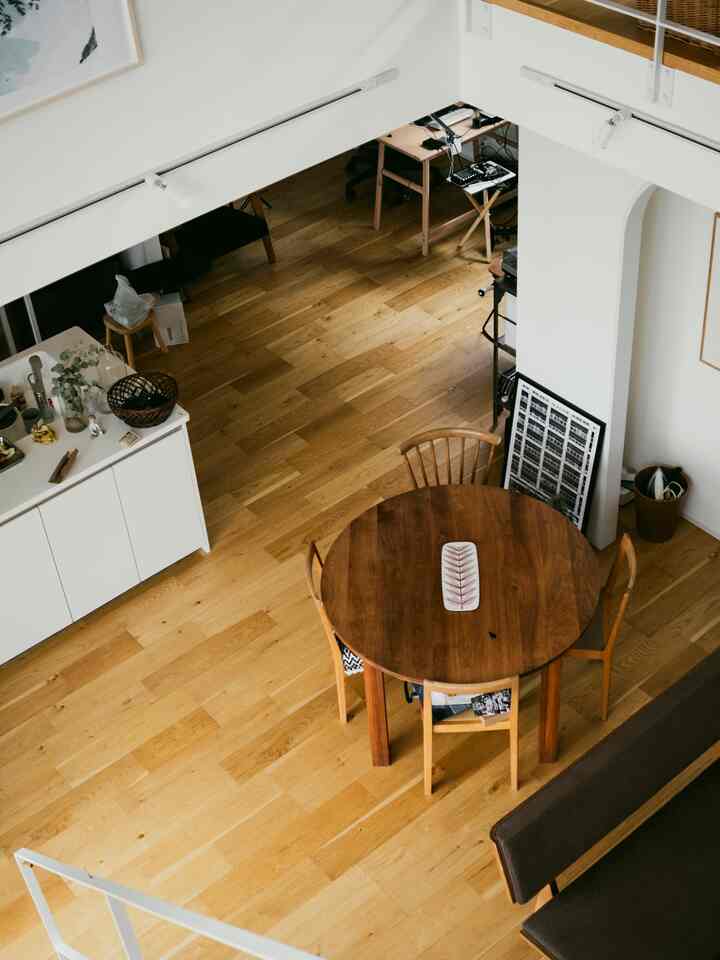 White and wood tone loft-style compact dining room with a home office area