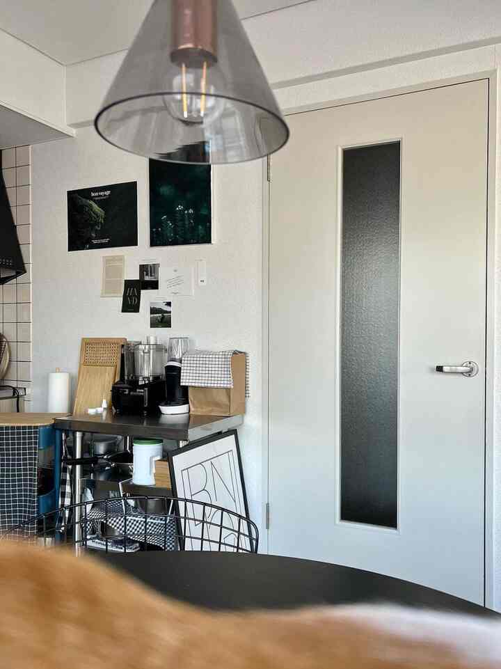 White-walled kitchen space featuring kitchen appliances and minimalist decor with a modern vibe