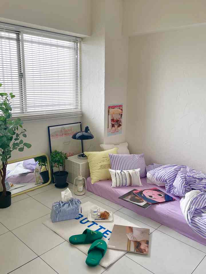 Natural white and purple toned 6-tatami bedroom featuring floor mattress, assorted cushions, side table, and cozy rug