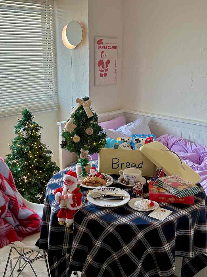 White and blue toned bedroom featuring a round table and Christmas mini trees creating a cozy home cafe atmosphere