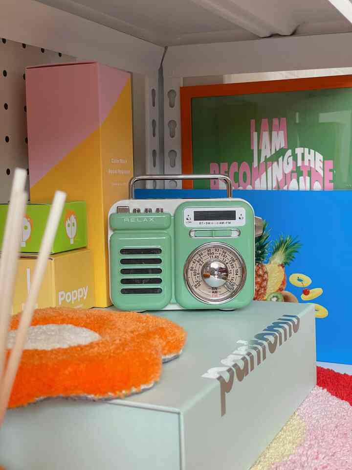 A summer-themed display shelf featuring retro-style mint and blue tones accented with colorful color-block items