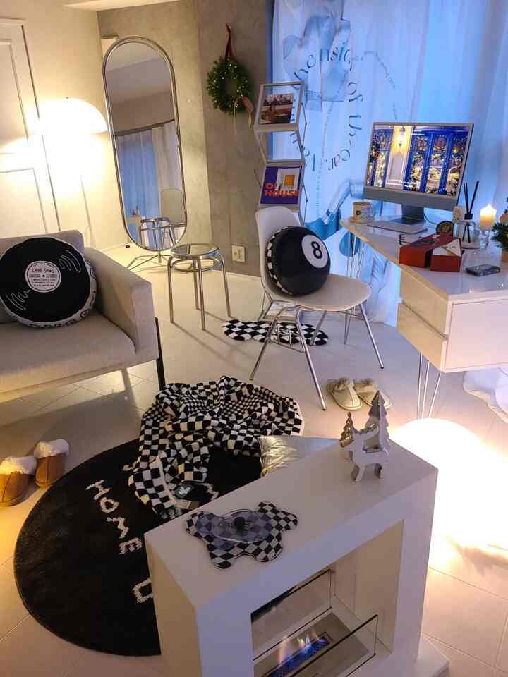 Modern white-toned living and home office space featuring silver accents and cozy furnishings