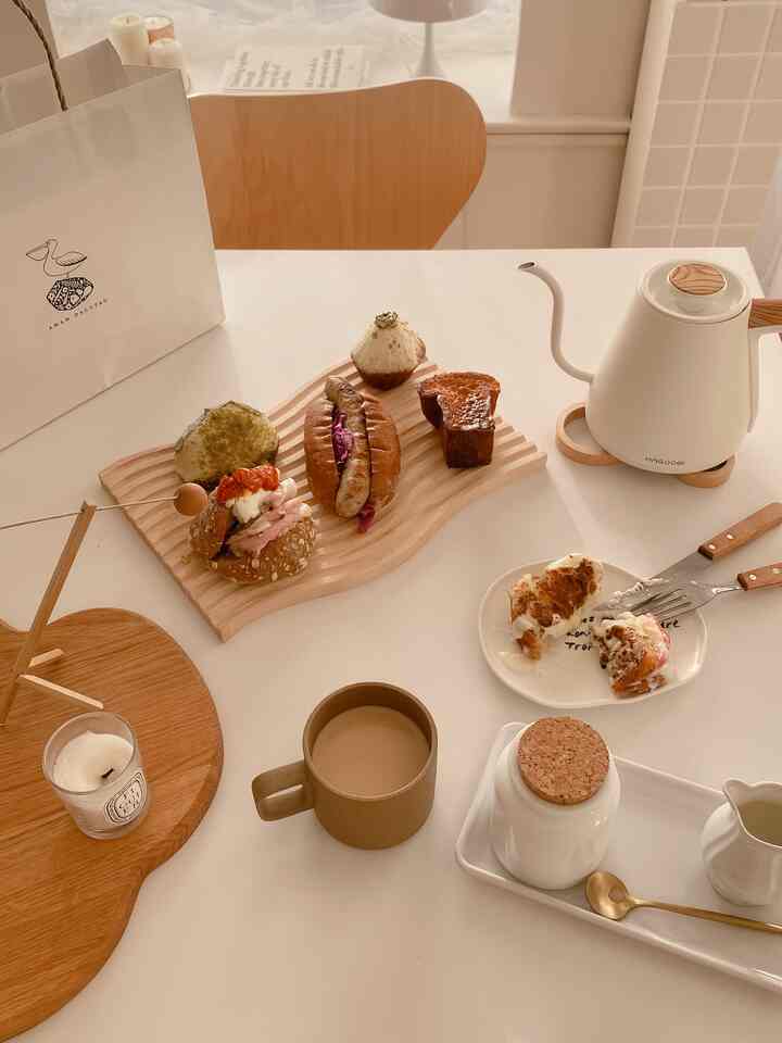 Natural-toned dining table featuring home cafe elements and assorted breads in a simple setting