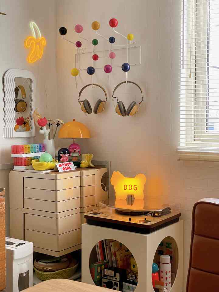 Cozy retro space with white walls, beige drawer cabinet, yellow table lamp, and dog-shaped night light