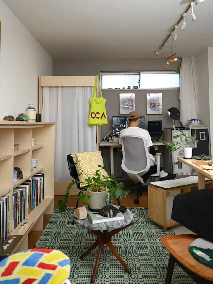 Compact home office space featuring white and wood tones, with central office chair and desk setup