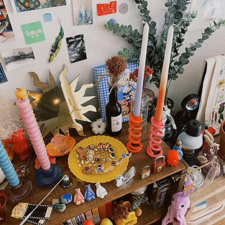 木目調のテーブルにカラフルなキャンドルとアクセサリーが並ぶナチュラルな雰囲気のディスプレイスペース