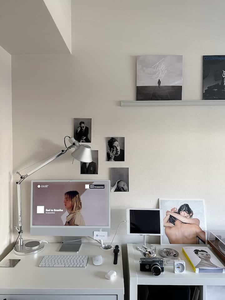 White-toned home office space featuring a white desk and silver table lamp in a clean modern style interior