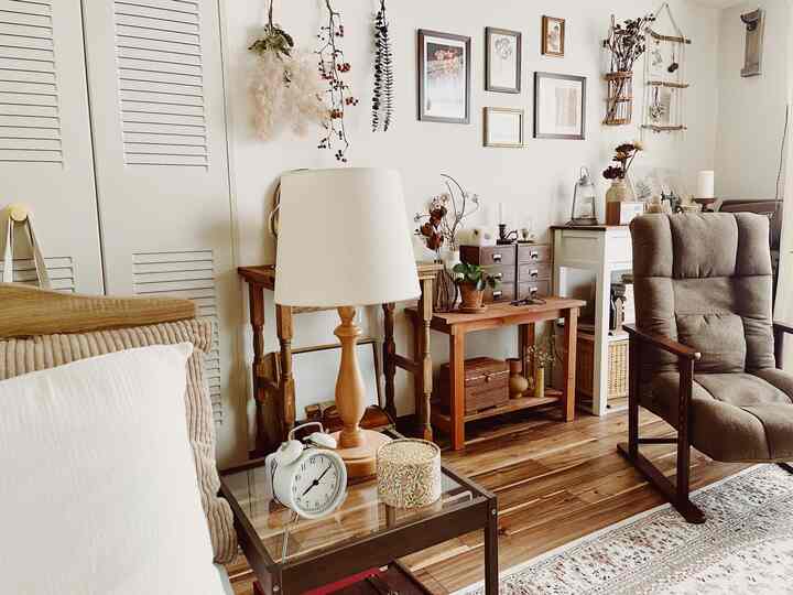 Warm brown and natural toned living room featuring wooden furniture and a comfy armchair creating a cozy atmosphere