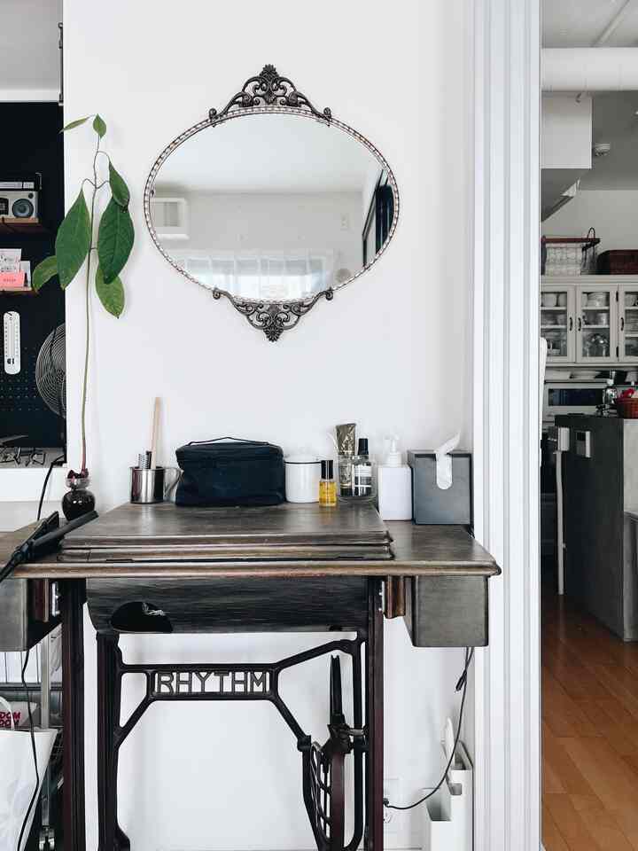 Natural small vanity space with white walls and brown wooden dressing table