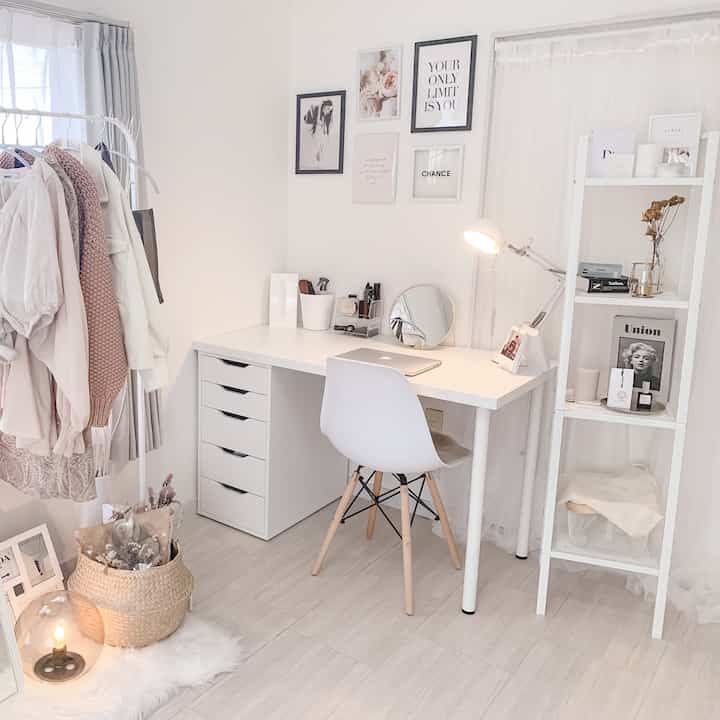 Bright white and gray toned home office space featuring a clean desk, chair, and storage shelves in a modern cozy interior