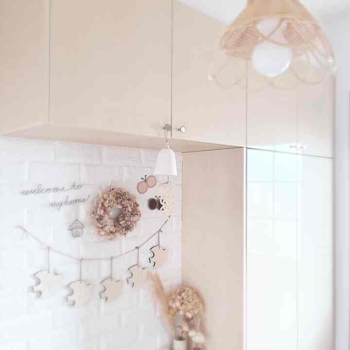 Natural beige-toned entrance featuring rattan lighting and wall decor creating a cozy atmosphere