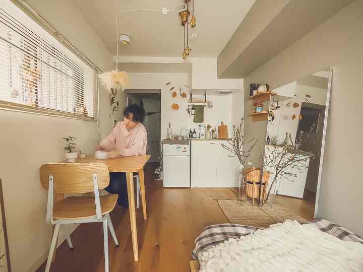 Natural brown wood tones and white small single household dining room and kitchen space blending warmth and simplicity