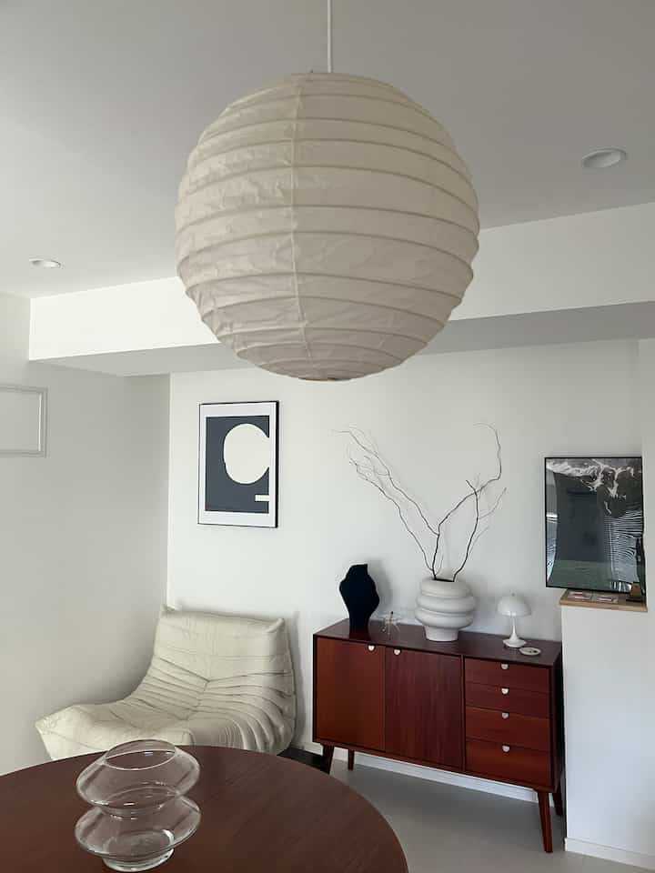 White and brown toned living room featuring a round table and a comfortable sofa with modern, cozy ambiance