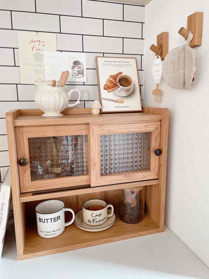 Natural color wooden mini storage cabinet and wall-mounted hooks in a cozy home cafe corner