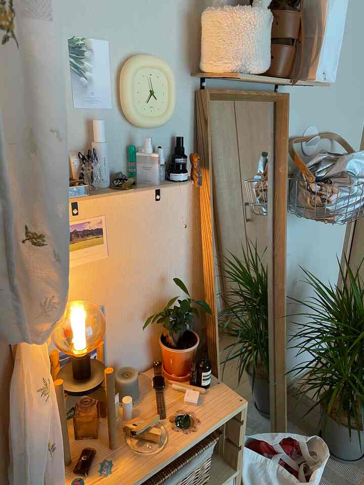 Natural wood tone small space featuring plants, a wall clock, and a glowing lamp creating a warm atmosphere