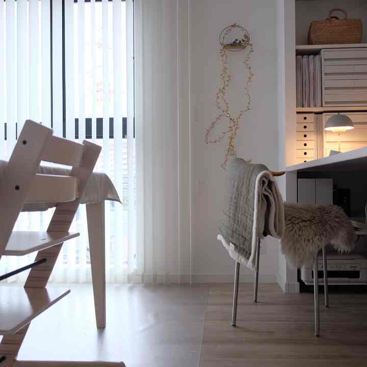 White and wood tone two-person household home office and dining room space, neat and cozy atmosphere