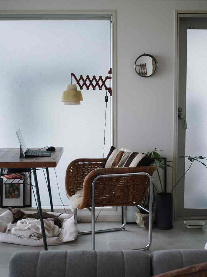 White-toned home office with brown furniture, calm remote work space featuring a pet bed for a dog