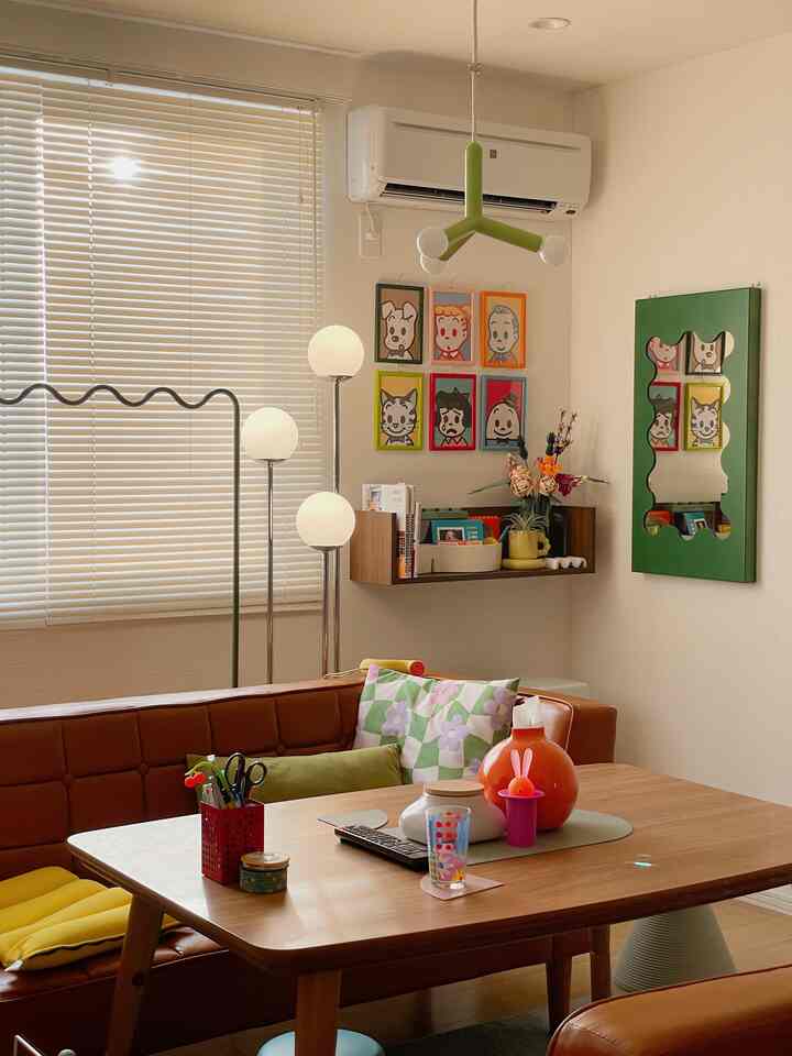 Warm brown and white tone living room featuring mid-century modern leather sofa, wooden table, and wall art creating a cozy atmosphere