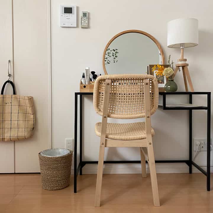 Natural wood tone and white-toned vanity and desk in a neat, minimal space