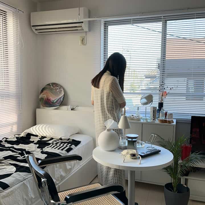 White-toned 29㎡ 1K bedroom featuring rattan chair, plant, and art decor creating a natural ambiance