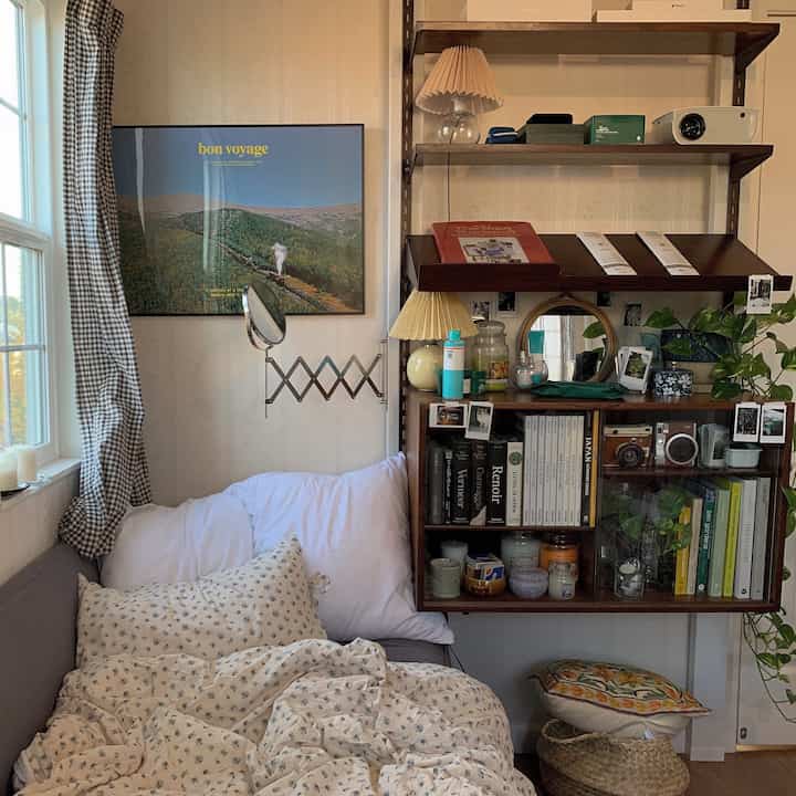 White and beige toned bedroom featuring floral duvet cover and wall poster with natural modern style interior