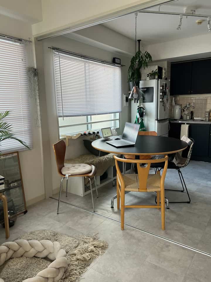White and black toned dining room featuring a round table with chairs centrally arranged in a modern setting