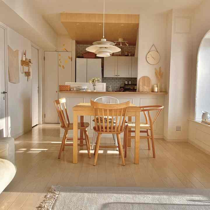 White and wood tone dining room and kitchen featuring simple, natural atmosphere