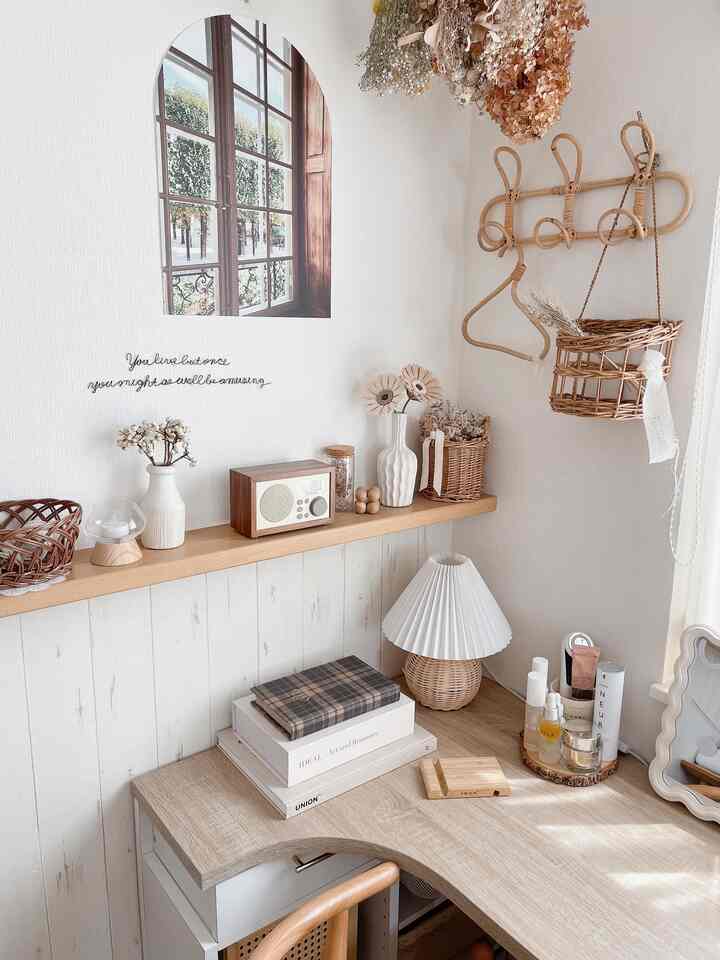 White and natural toned powder room featuring a corner desk, shelves, and natural decor for a cozy atmosphere