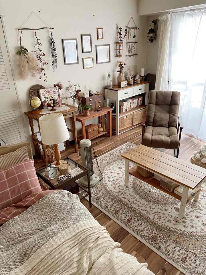 A cozy living room with natural wood tones and white hues, featuring various storage furniture and vintage decor elements