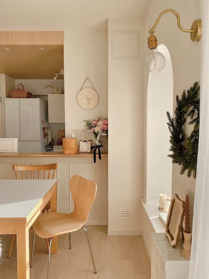 Natural-toned kitchen and dining room featuring wooden table and chairs with cozy atmosphere