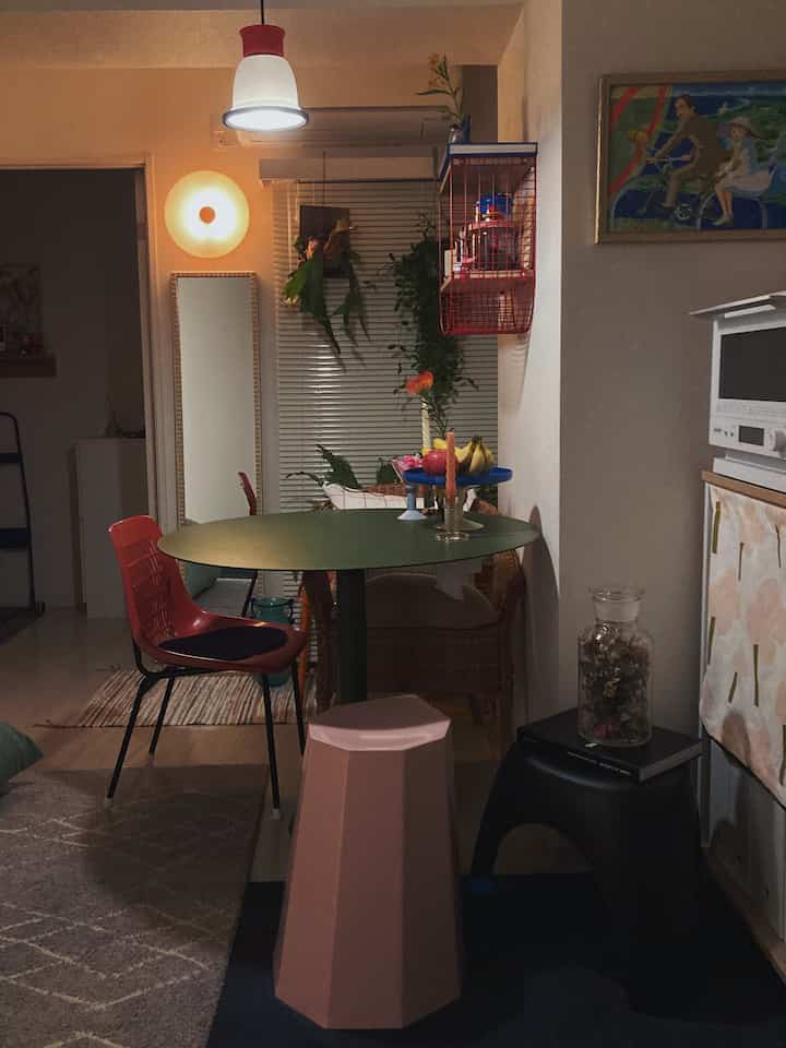 Brown and red toned two-person dining room featuring stools and pendant lighting creating a warm atmosphere