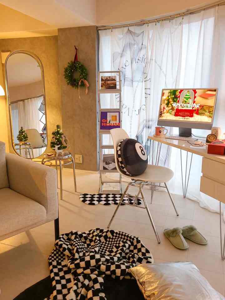 White and silver toned compact home office featuring armchair, stool, and bookshelf with a modern atmosphere
