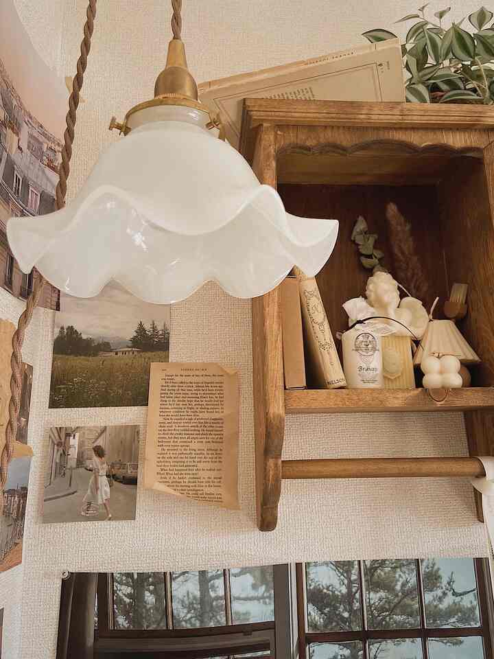 Natural home office space featuring wood tone wall shelf and milk glass pendant light