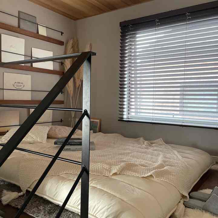 Natural-toned bedroom space featuring thick futon bedding on floor with cozy and calm atmosphere