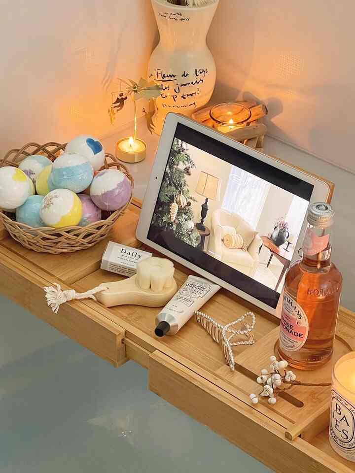 Natural wood-tone bath tray with bathroom essentials and vase, creating a cozy relaxation space in the bathroom