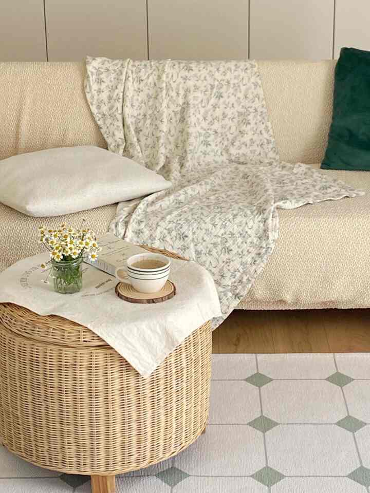 Beige natural-toned living room featuring a natural fabric sofa and rattan side table with a cozy ambiance