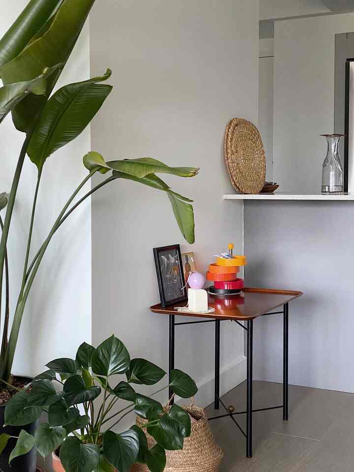 Natural color kitchen corner featuring a stool, plants, and rattan accessories with a modern vibe