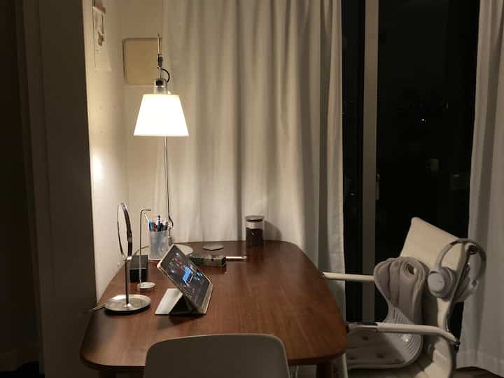 White and brown toned home office featuring a wooden desk and office chair in a cozy workspace