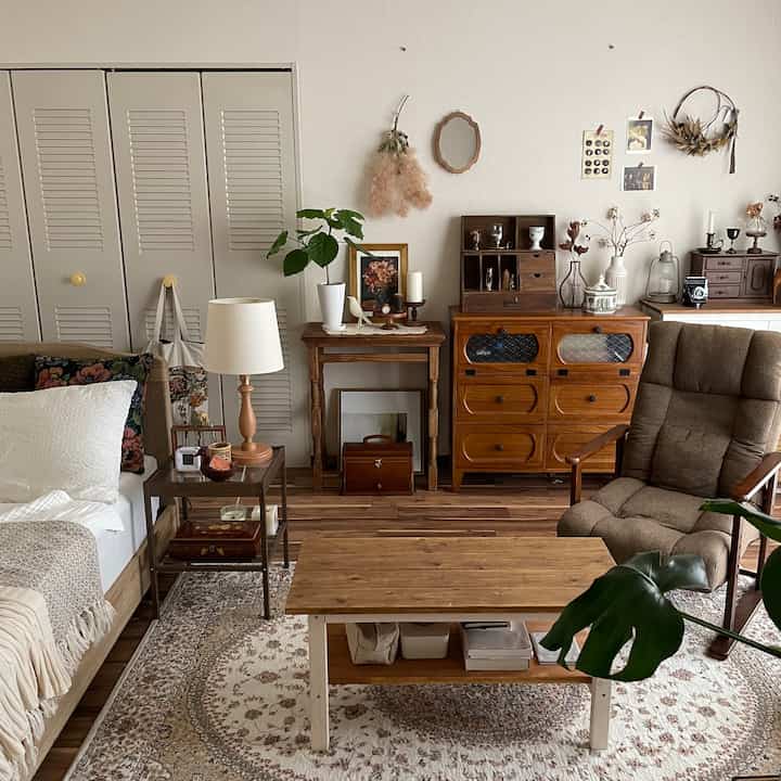 Natural brown and white toned living room featuring wooden furniture, a rug, and an armchair with a warm atmosphere