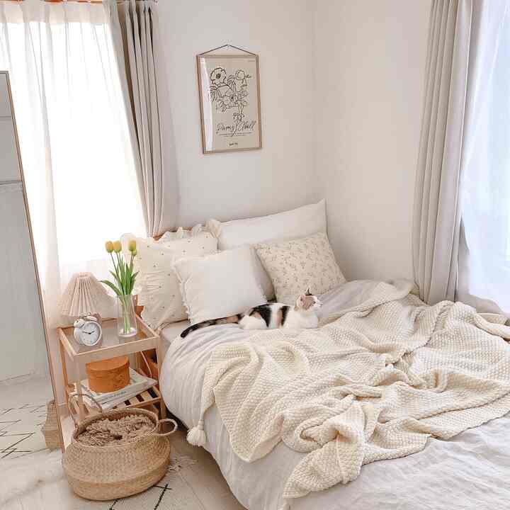 Bright natural color toned 6-tatami bedroom featuring a cat on the bed and a nightstand creating a cozy atmosphere