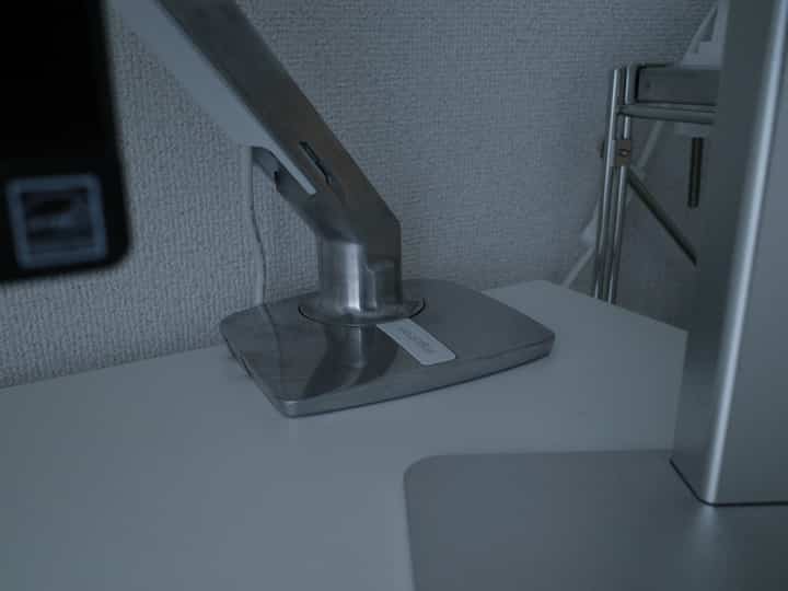 Silver-toned home office space featuring aluminum monitor arm on a clean desk setup