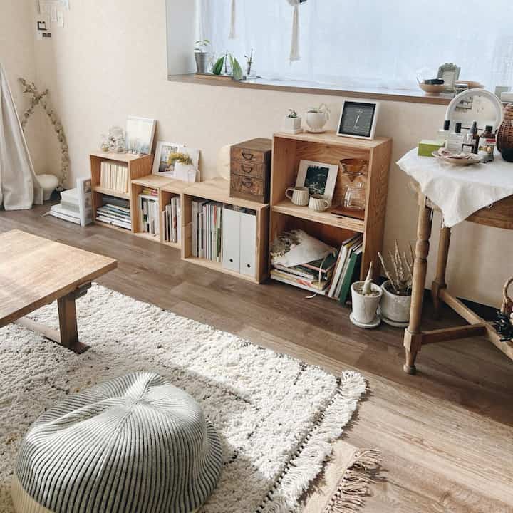 A natural dining room dominated by beige and wood tones featuring window shelves and a coffee drip set in a cozy atmosphere